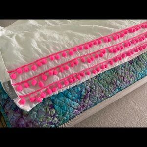 The Land of Nod crib skirt w/ hot pink pompoms!